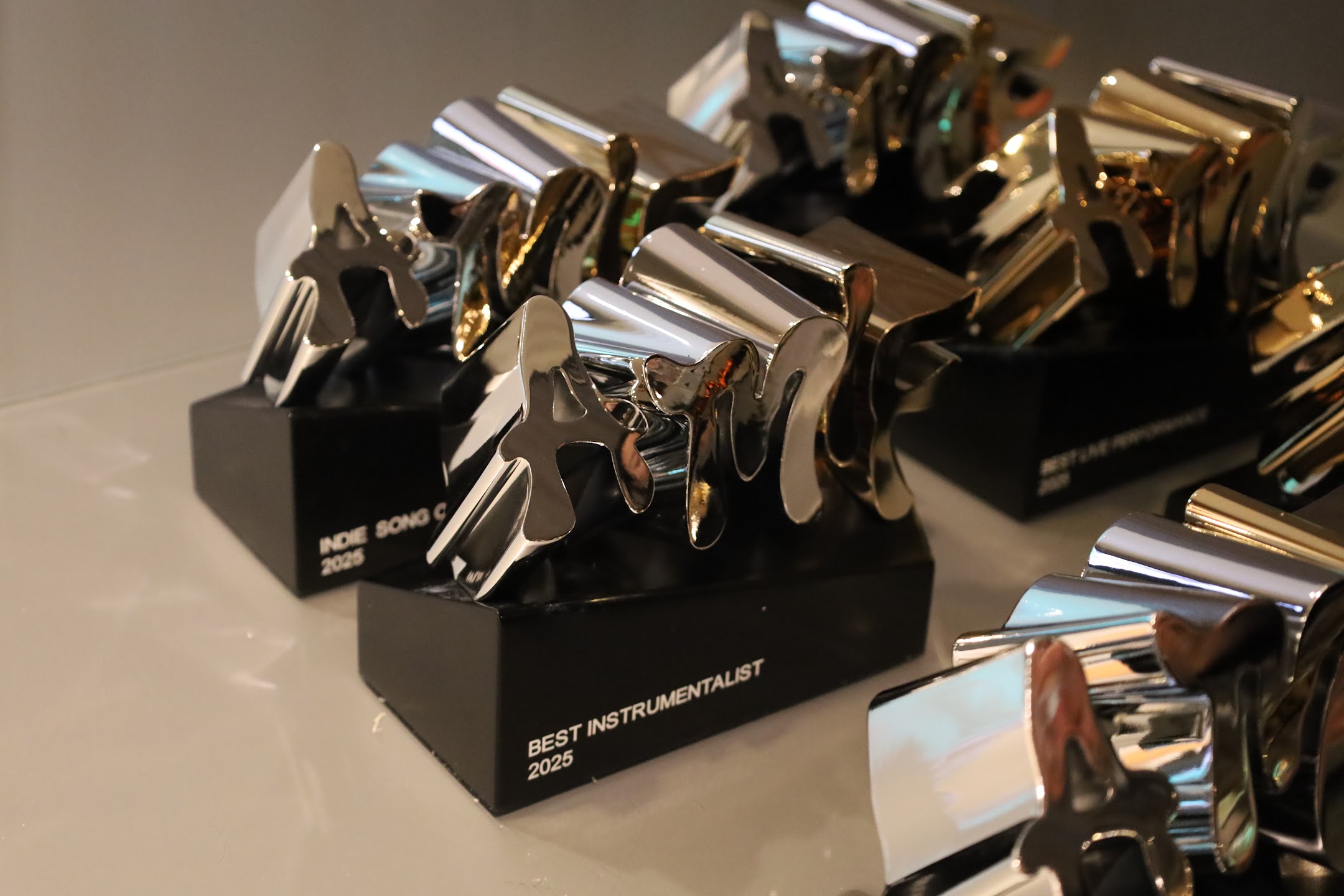 Silver AMIF trophies catching the light at the 2025 awards ceremony