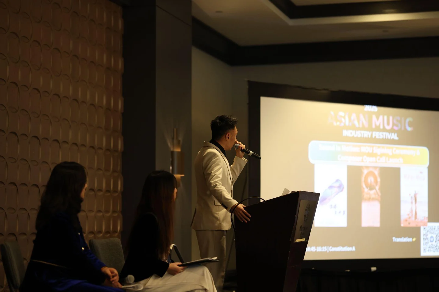 A film and music industry speaker at the AMIF lectern