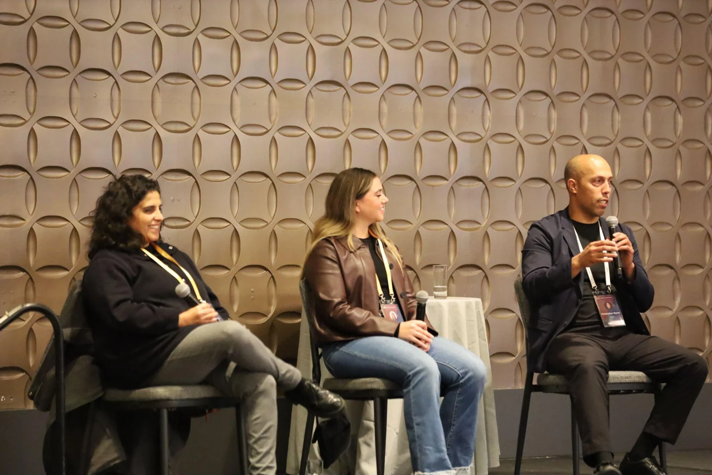 Three AMIF panelists discussing artist development on stage